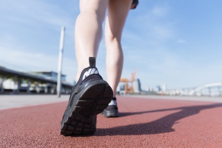 阳光下运动女孩跑道上走路